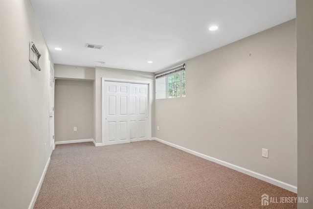 unfurnished bedroom with carpet, baseboards, recessed lighting, and a closet