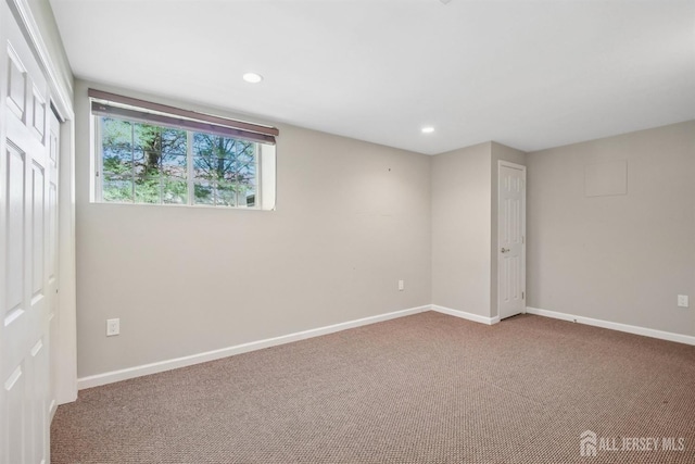 below grade area with carpet flooring, baseboards, and recessed lighting