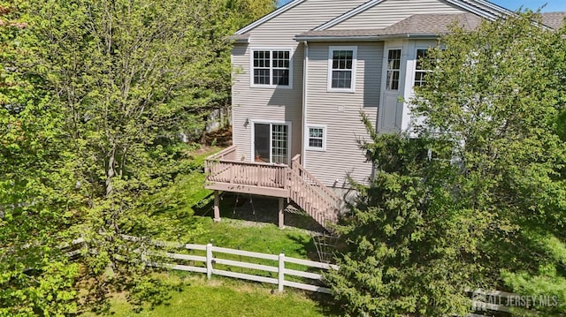 rear view of house featuring fence, a deck, and stairway