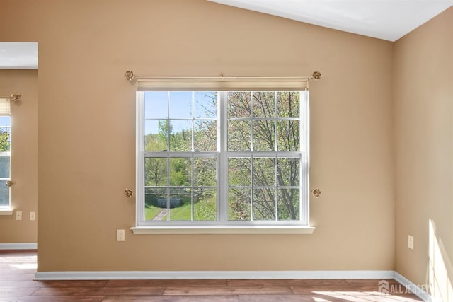 unfurnished room with wood finished floors and baseboards