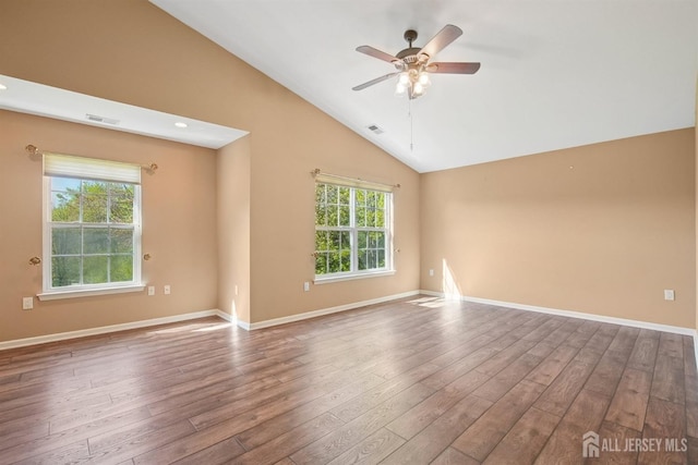 spare room featuring lofted ceiling, wood finished floors, ceiling fan, and baseboards
