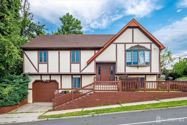 221 S Pine Ave S, South Amboy, NJ 08879 - tudor home featuring stucco siding, an attached garage, and driveway
