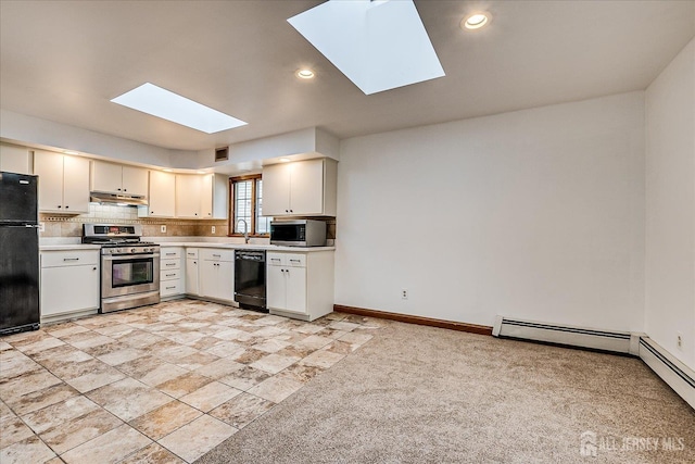 221 S Pine Ave S, South Amboy, NJ 08879 - kitchen with black appliances, a skylight, under cabinet range hood, light countertops, and recessed lighting