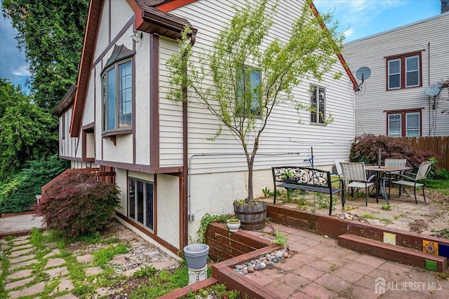 221 S Pine Ave S, South Amboy, NJ 08879 - view of side of property with a patio area, stucco siding, and outdoor dining space