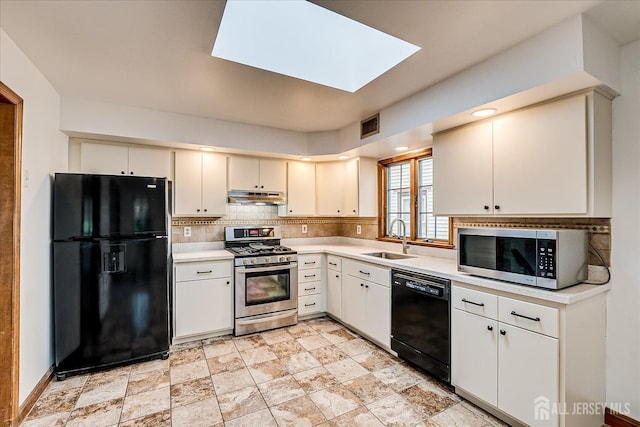 221 S Pine Ave S, South Amboy, NJ 08879 - kitchen featuring black appliances, under cabinet range hood, light countertops, and decorative backsplash