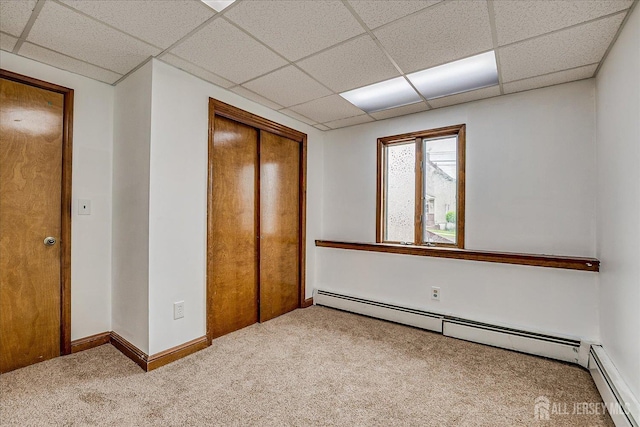 221 S Pine Ave S, South Amboy, NJ 08879 - unfurnished bedroom featuring a baseboard radiator, carpet, a paneled ceiling, and a closet