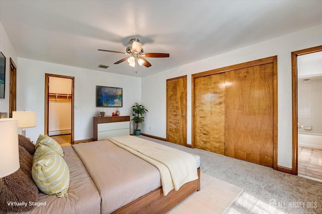 221 S Pine Ave S, South Amboy, NJ 08879 - bedroom featuring a baseboard radiator, multiple closets, carpet flooring, ensuite bath, and ceiling fan