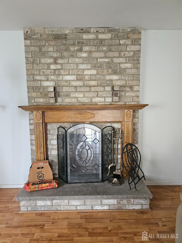 22 Victory Ct, Old Bridge, NJ 08857 - detailed view of a brick fireplace and wood finished floors