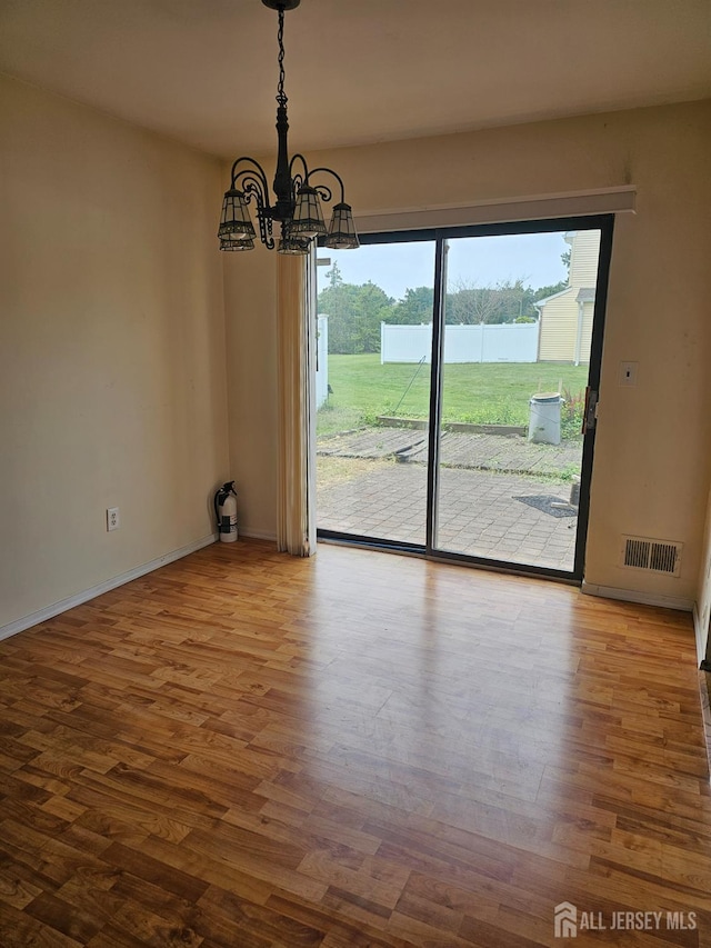 22 Victory Ct, Old Bridge, NJ 08857 - unfurnished dining area with wood finished floors and a chandelier