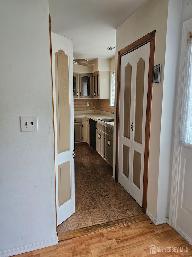 22 Victory Ct, Old Bridge, NJ 08857 - kitchen with black dishwasher, wood finished floors, light countertops, and decorative backsplash