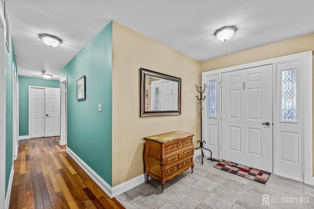 entryway featuring light wood-type flooring and baseboards