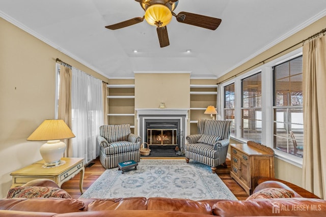 15 John Adams Ct, Monroe, NJ 08831 - living area with vaulted ceiling, wood finished floors, a ceiling fan, a glass covered fireplace, and built in shelves