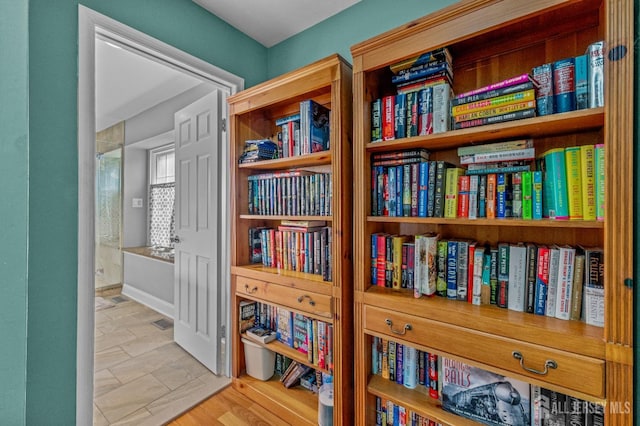 interior space featuring baseboards and wood finished floors