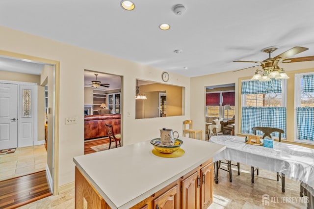 15 John Adams Ct, Monroe, NJ 08831 - kitchen featuring a ceiling fan, light countertops, a center island, brown cabinetry, and recessed lighting