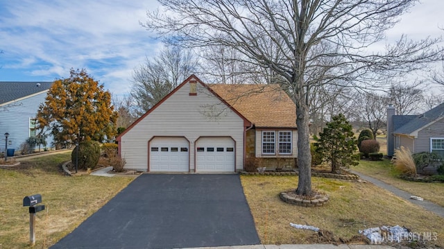 view of front of home featuring a garage, driveway, and a front lawn