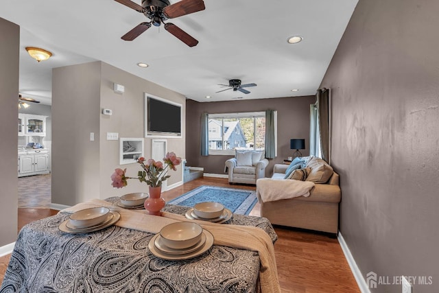 living area with recessed lighting, baseboards, and wood finished floors