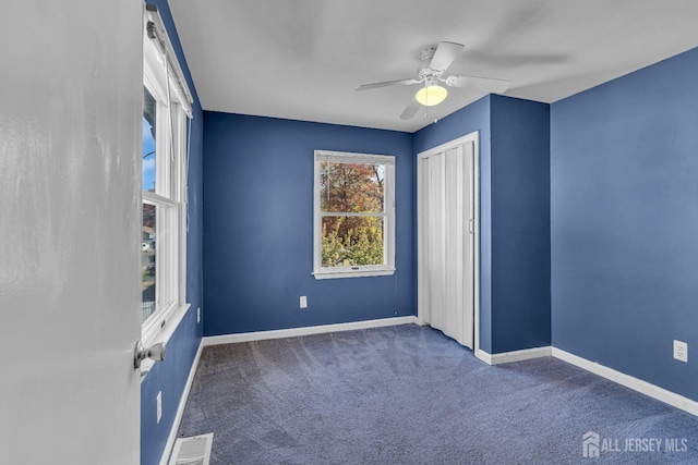 unfurnished bedroom with baseboards, visible vents, ceiling fan, carpet floors, and a closet