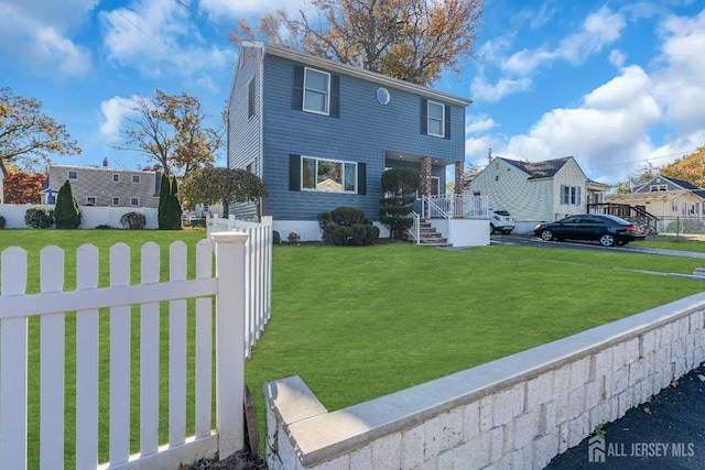 view of front of property with a fenced front yard and a front yard