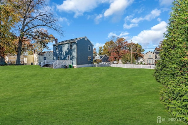 view of yard with fence and a deck