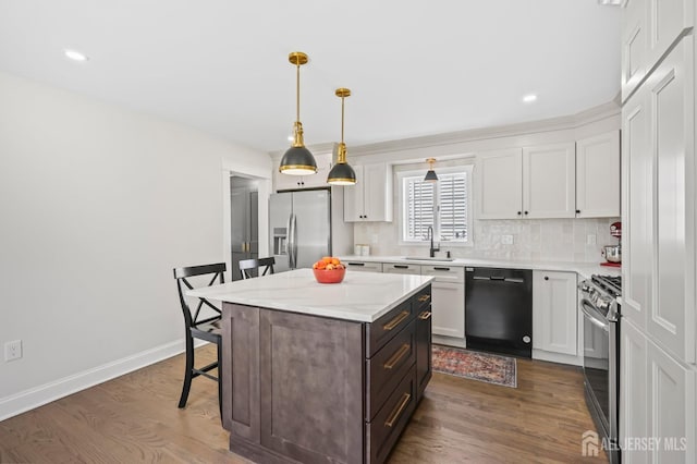 39 Embroidery St, Sayreville, NJ 08879 - kitchen featuring stainless steel appliances, a kitchen breakfast bar, a center island, tasteful backsplash, and white cabinetry