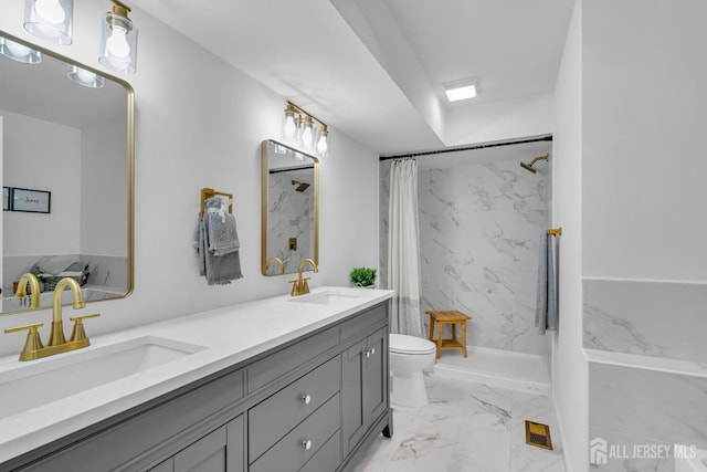 bathroom with a marble finish shower, marble finish floor, toilet, and a sink