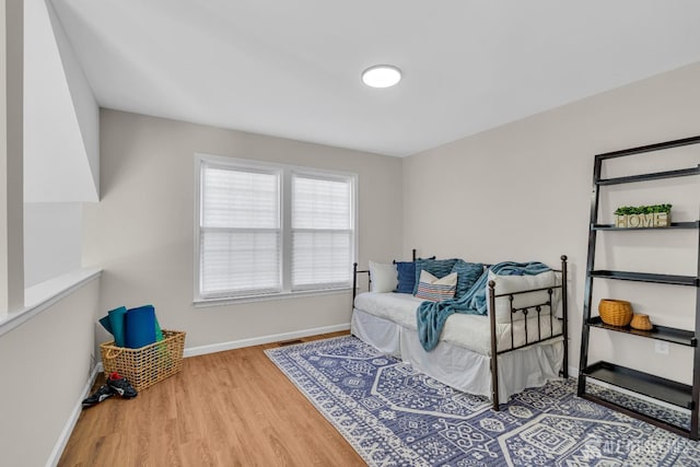 sitting room with visible vents, baseboards, and wood finished floors