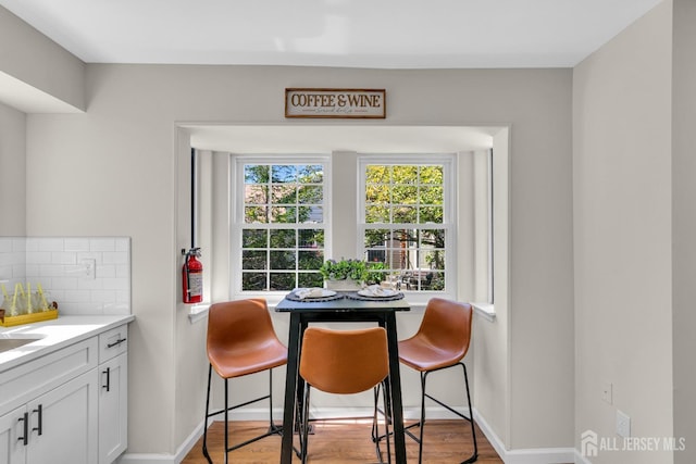 dining area with light wood-style flooring and baseboards