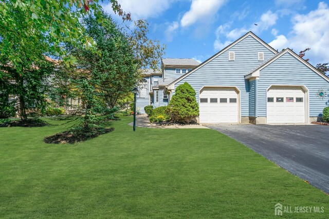 front of property featuring a garage and a front lawn