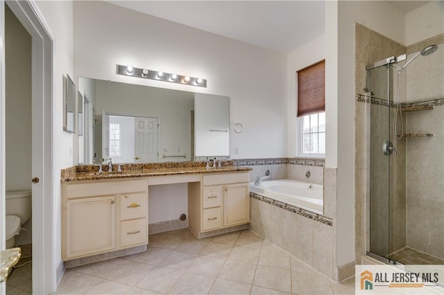 full bath with a garden tub, a sink, tile patterned floors, double vanity, and a stall shower