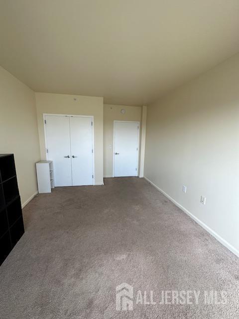 110 Somerset St Unit 2101, New Brunswick, NJ 08901 - unfurnished bedroom featuring carpet and a closet
