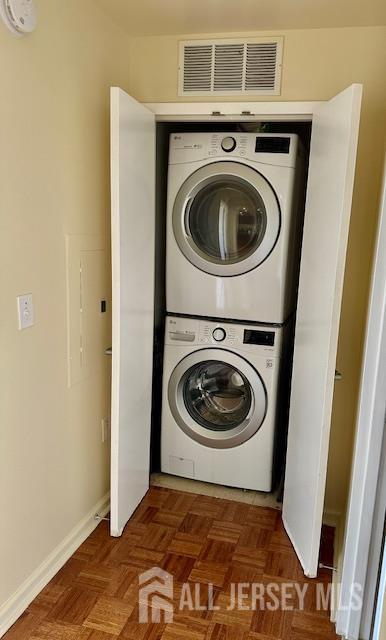 110 Somerset St Unit 2101, New Brunswick, NJ 08901 - washroom featuring stacked washer / dryer and baseboards