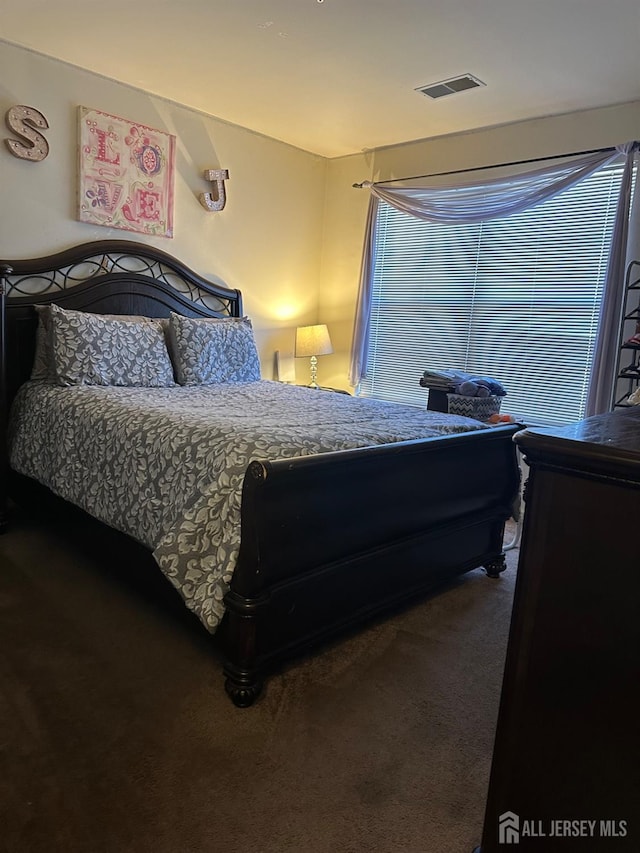 carpeted bedroom with visible vents