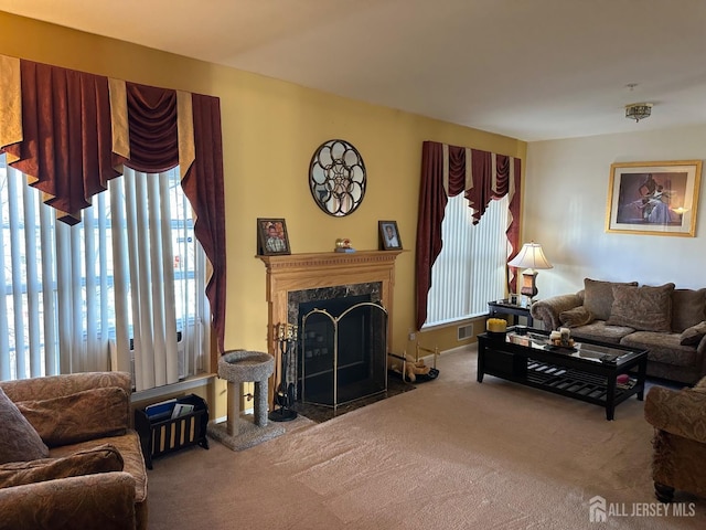 carpeted living area with a high end fireplace