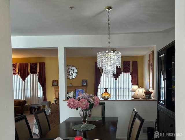 dining space featuring visible vents and a chandelier