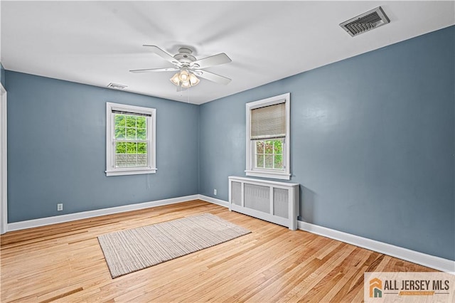 57 Patton Dr, East Brunswick, NJ 08816 - empty room with radiator, ceiling fan, wood finished floors, and baseboards