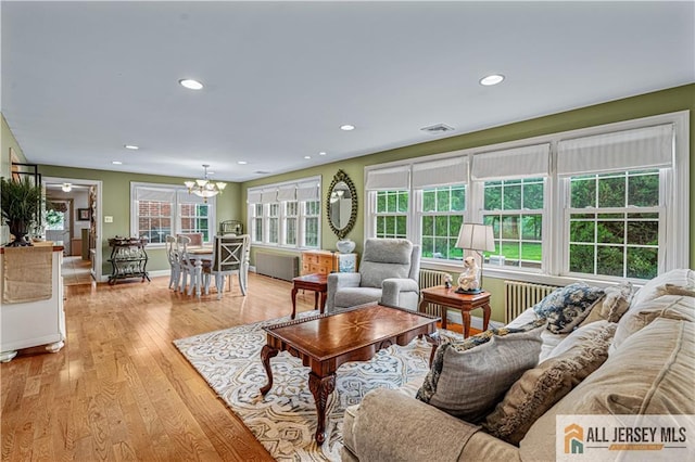 57 Patton Dr, East Brunswick, NJ 08816 - living room with a chandelier, plenty of natural light, light wood-type flooring, recessed lighting, and baseboards