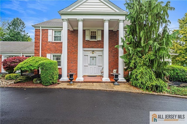 57 Patton Dr, East Brunswick, NJ 08816 - neoclassical / greek revival house with brick siding and a porch