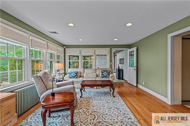 57 Patton Dr, East Brunswick, NJ 08816 - living area featuring radiator, recessed lighting, baseboards, and light wood-style flooring