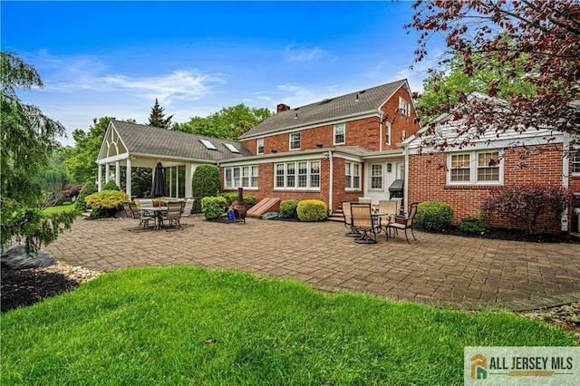57 Patton Dr, East Brunswick, NJ 08816 - back of house featuring a patio area, brick siding, a lawn, and a gazebo