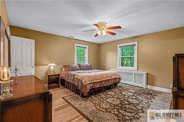 57 Patton Dr, East Brunswick, NJ 08816 - bedroom featuring radiator heating unit, wood finished floors, and a ceiling fan