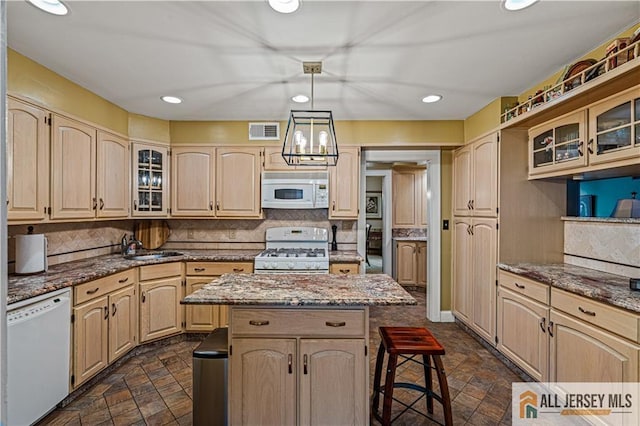 57 Patton Dr, East Brunswick, NJ 08816 - kitchen featuring white appliances, stone finish flooring, a breakfast bar, light brown cabinetry, and recessed lighting