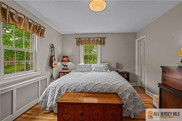 57 Patton Dr, East Brunswick, NJ 08816 - bedroom with radiator heating unit and wood finished floors