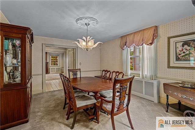 57 Patton Dr, East Brunswick, NJ 08816 - dining area featuring wallpapered walls, light carpet, a chandelier, and radiator