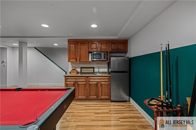 57 Patton Dr, East Brunswick, NJ 08816 - kitchen featuring stainless steel appliances, light wood-style flooring, a sink, brown cabinets, and recessed lighting