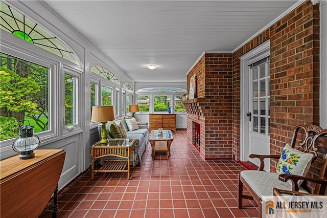 57 Patton Dr, East Brunswick, NJ 08816 - sunroom with tile patterned flooring, brick wall, and ornamental molding