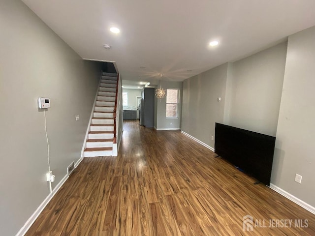 unfurnished living room with dark wood-type flooring