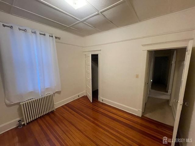 309 S 2nd Ave S, Highland Park, NJ 08904 - unfurnished bedroom featuring radiator heating unit, wood finished floors, baseboards, and a closet
