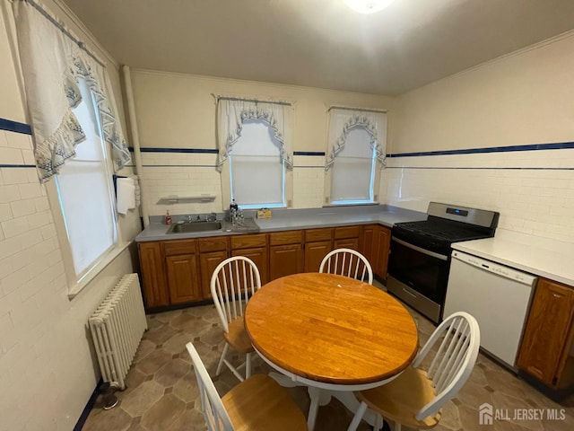 309 S 2nd Ave S, Highland Park, NJ 08904 - kitchen featuring radiator heating unit, gas stove, white dishwasher, and healthy amount of natural light