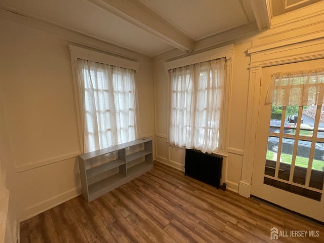 309 S 2nd Ave S, Highland Park, NJ 08904 - empty room with radiator heating unit, beam ceiling, and wood finished floors
