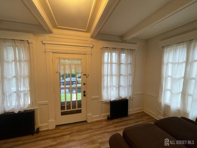 309 S 2nd Ave S, Highland Park, NJ 08904 - doorway to outside with radiator heating unit, ornamental molding, plenty of natural light, wood finished floors, and beamed ceiling